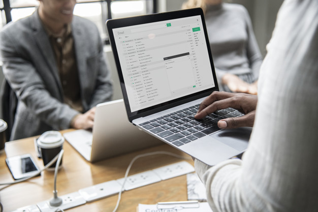 Man checking his email on a laptop Free Photo