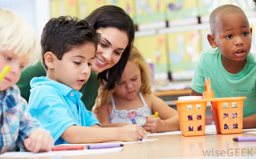 young-children-at-preschool-table-with-smiling-teacher-or-parent