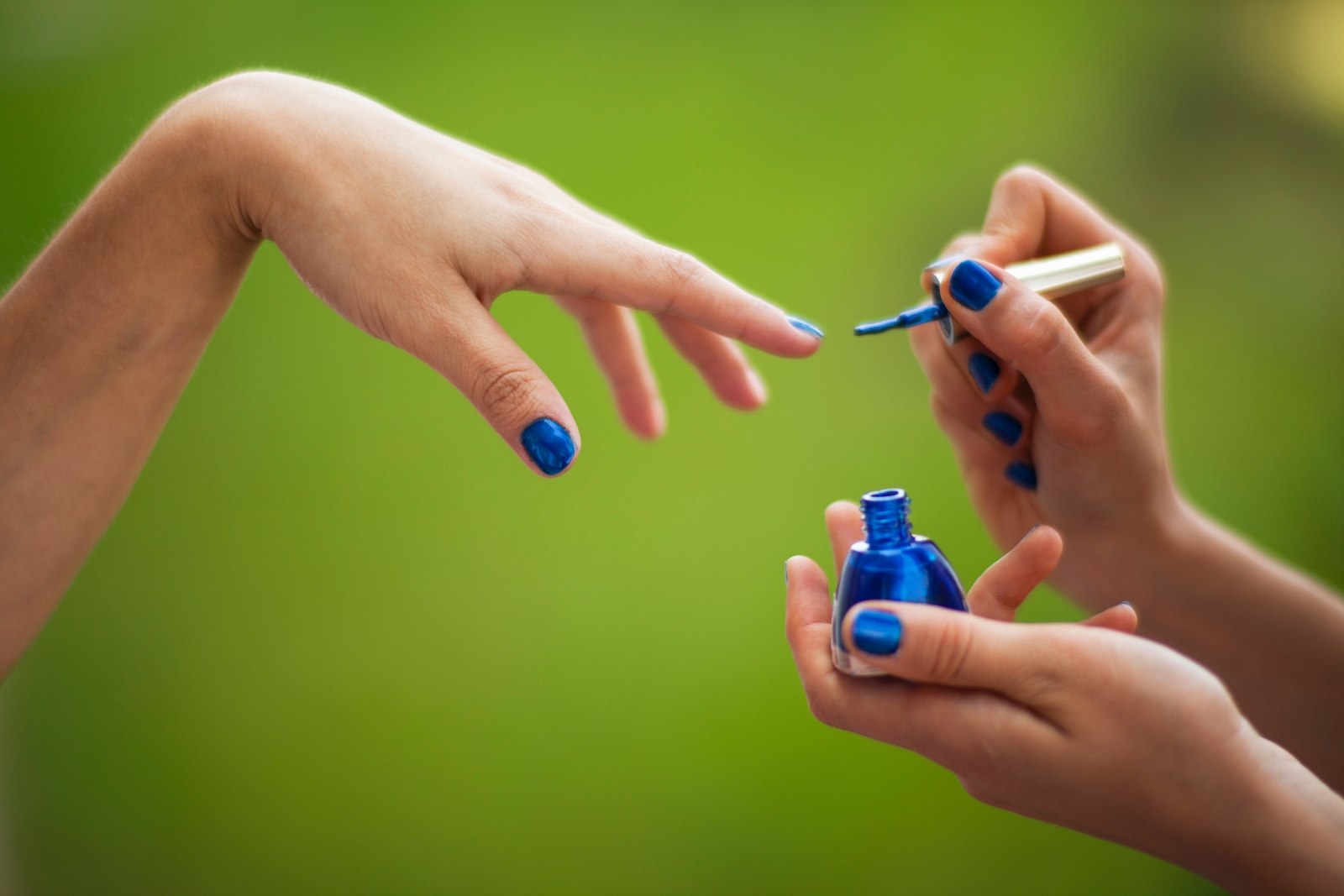 person holding blue and white plastic bottle