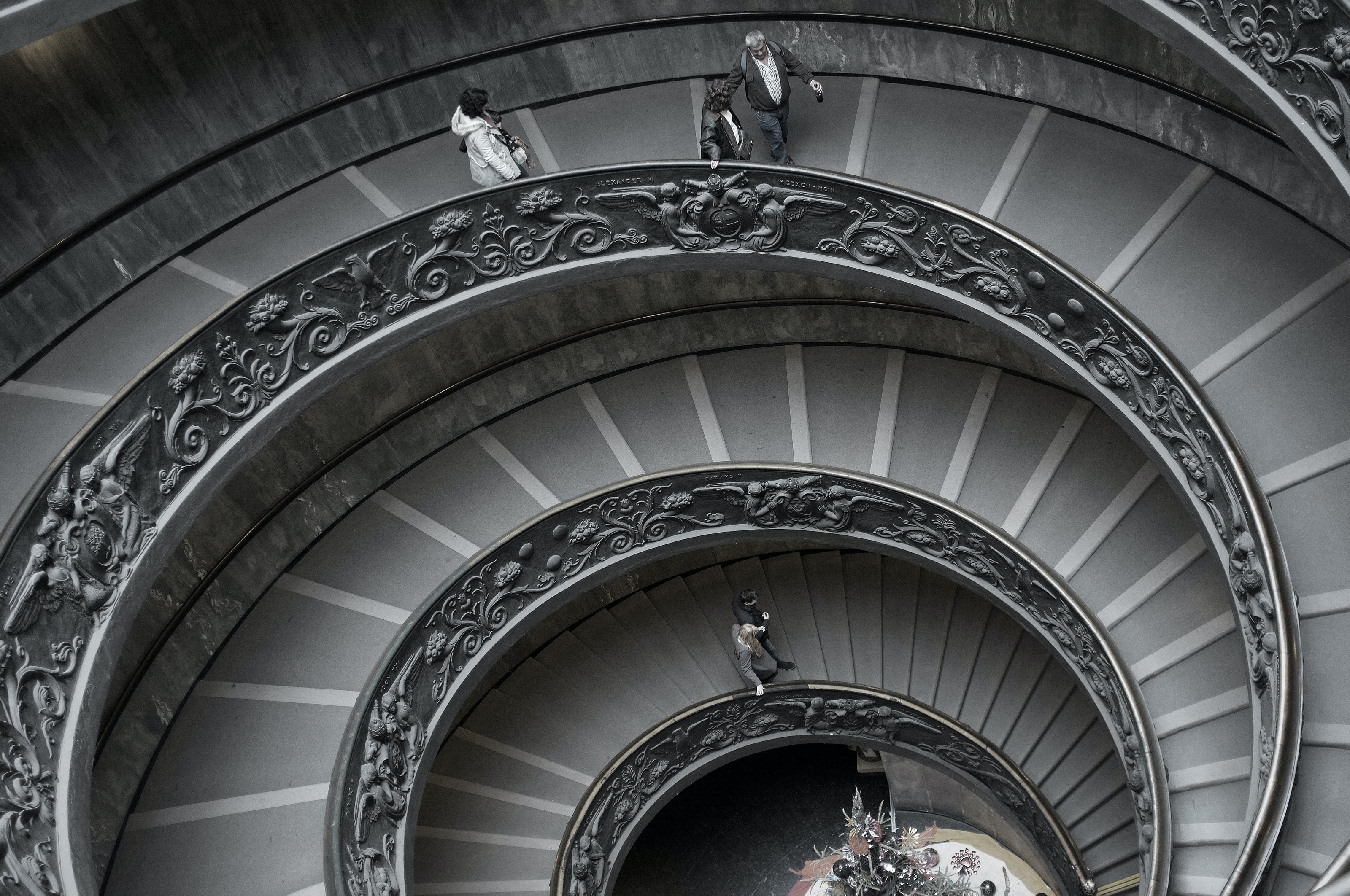 people walking on spiral staircase