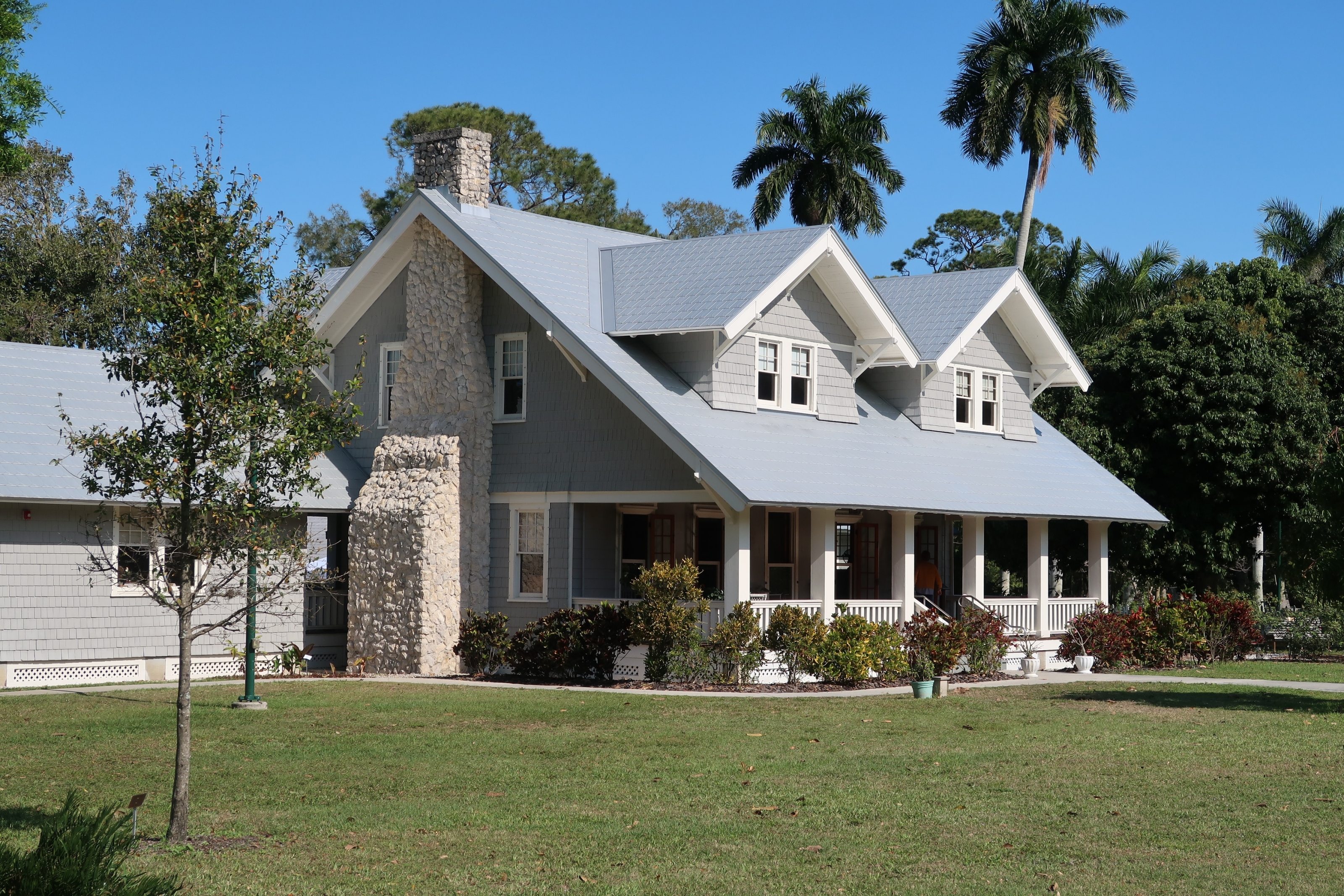 brown and white concrete house near green grass field during daytime