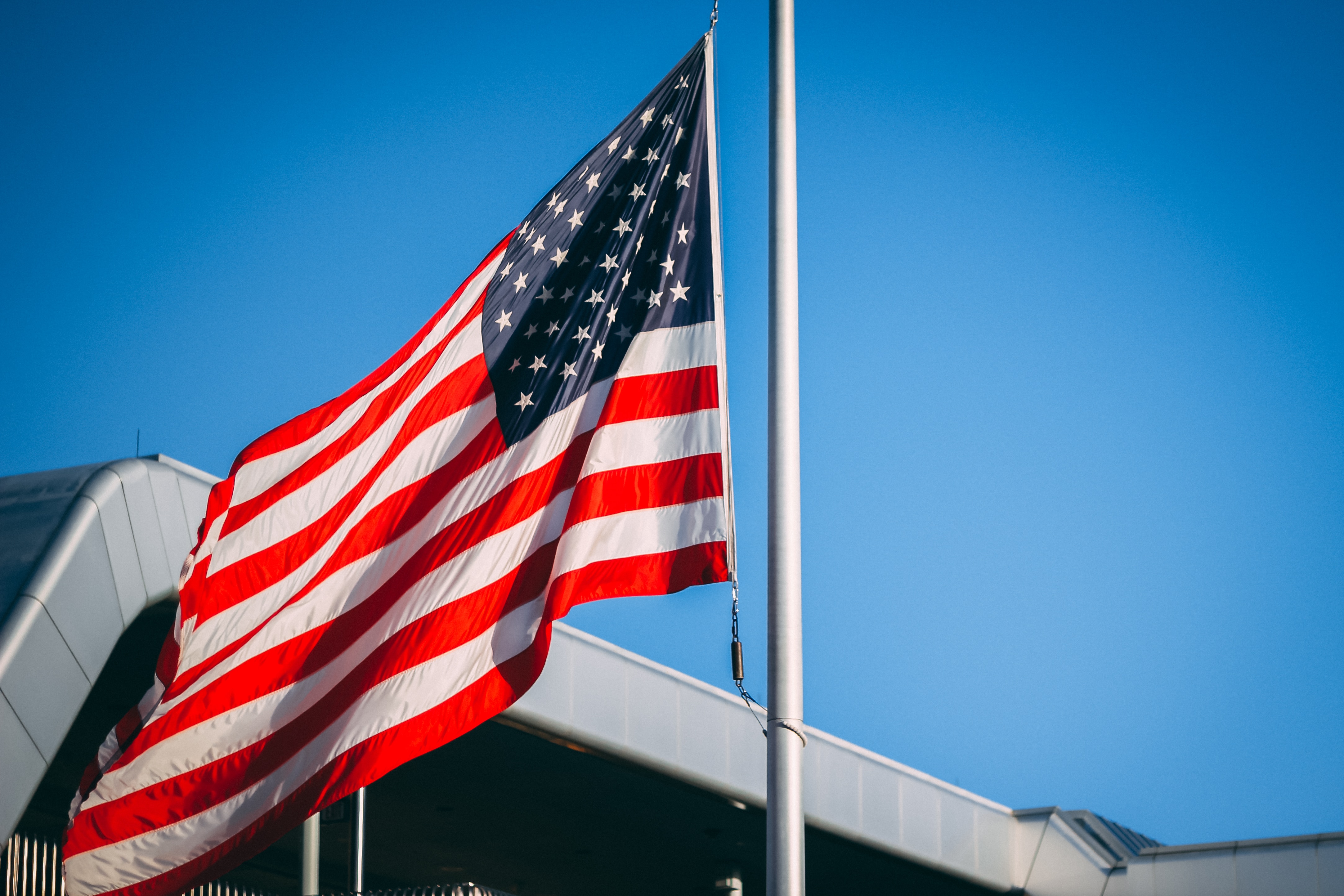 us a flag on pole during daytime